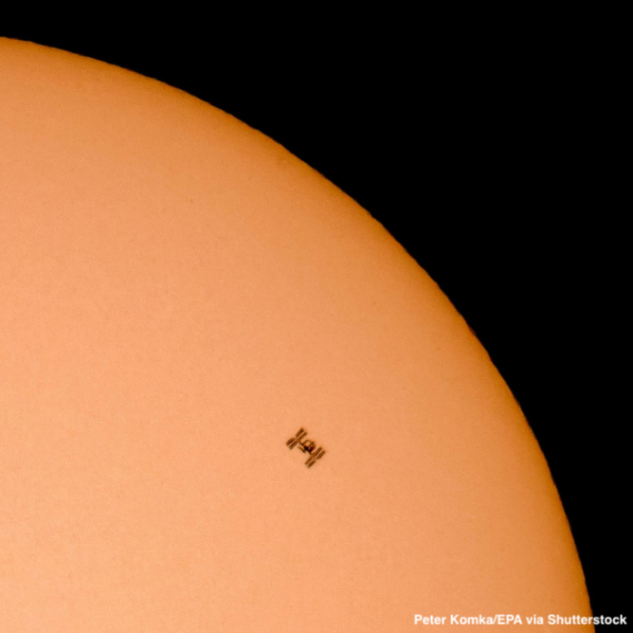 ISS flying in front of the sun